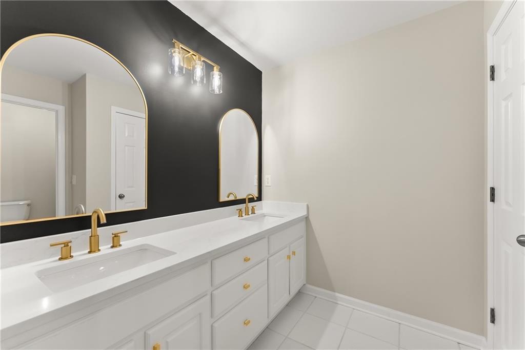 41 Doster Crest Road Jefferson, GA 30549 - Photo 31 of 56 a bathroom with a double vanity sink and a mirror