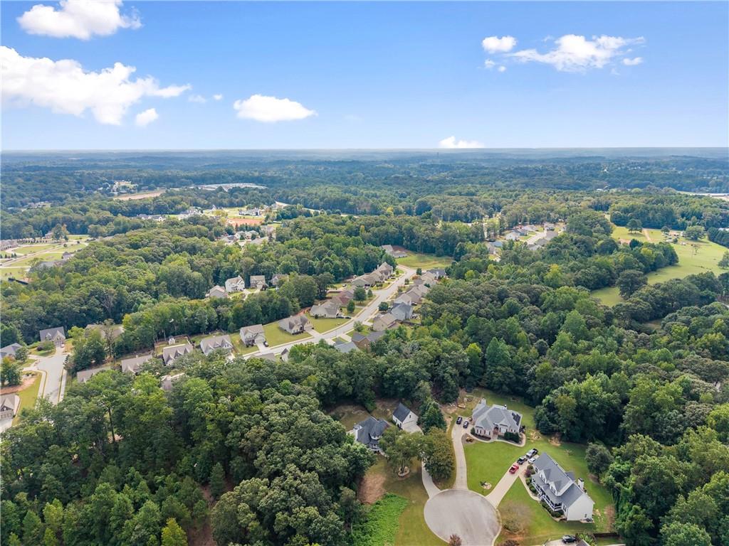 41 Doster Crest Road Jefferson, GA 30549 - Photo 54 of 56 an aerial view of a city with lots of residential buildings and mountain view in back
