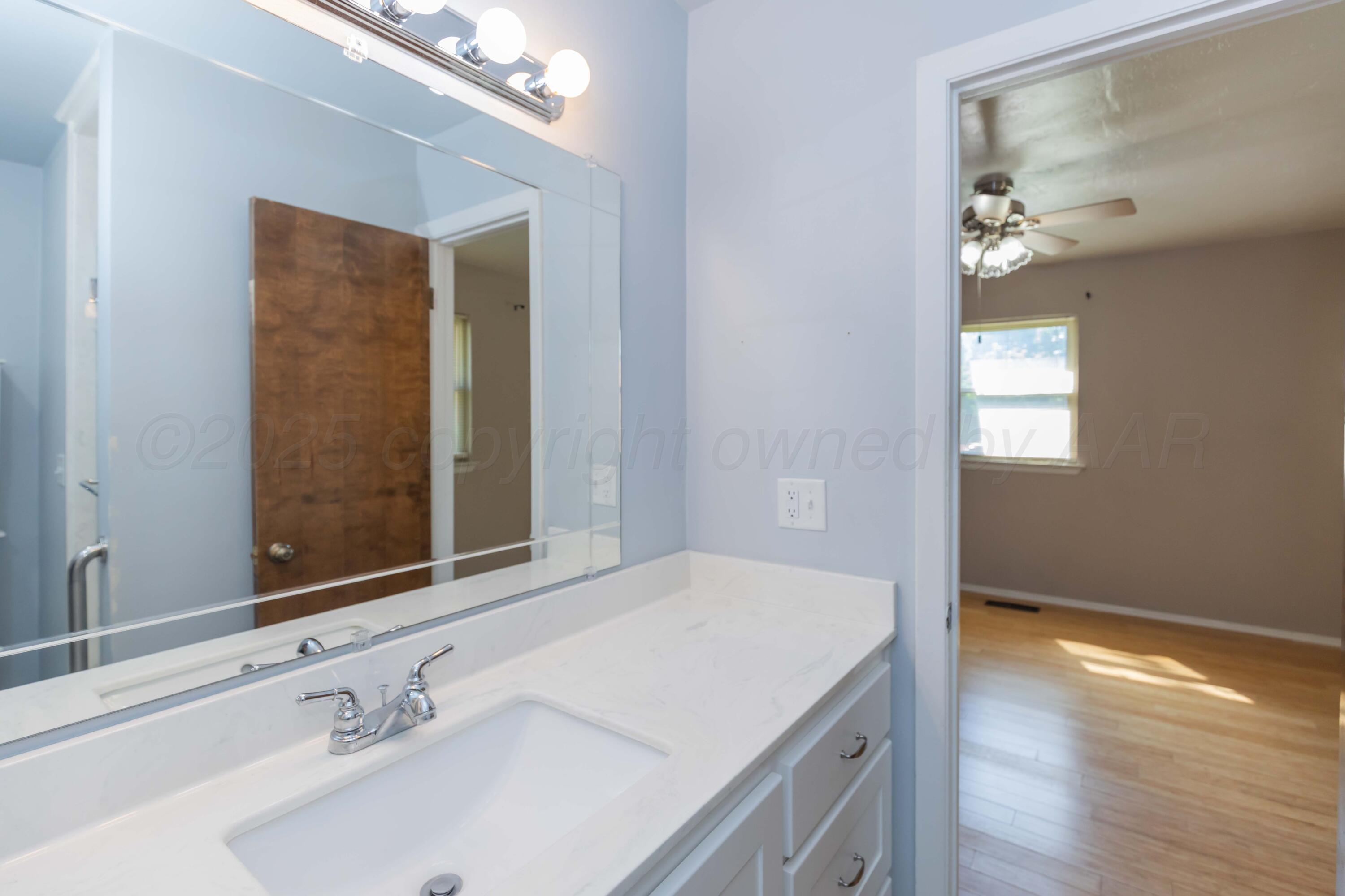 7000 Sunburst Street Amarillo, TX 79110 - Photo 15 of 32 a bathroom with a sink and a mirror