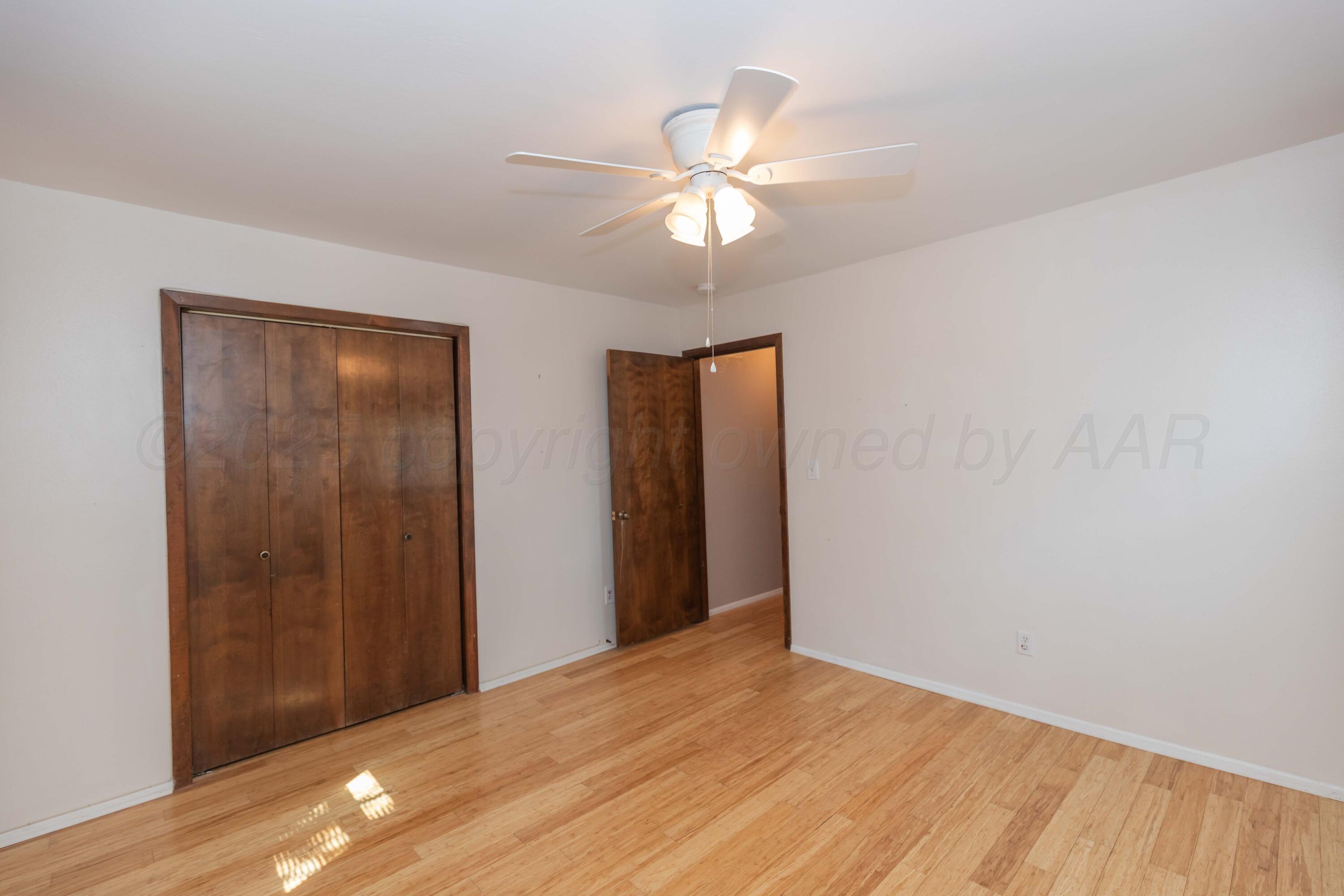 7000 Sunburst Street Amarillo, TX 79110 - Photo 21 of 32 a view of an empty room with wooden floor