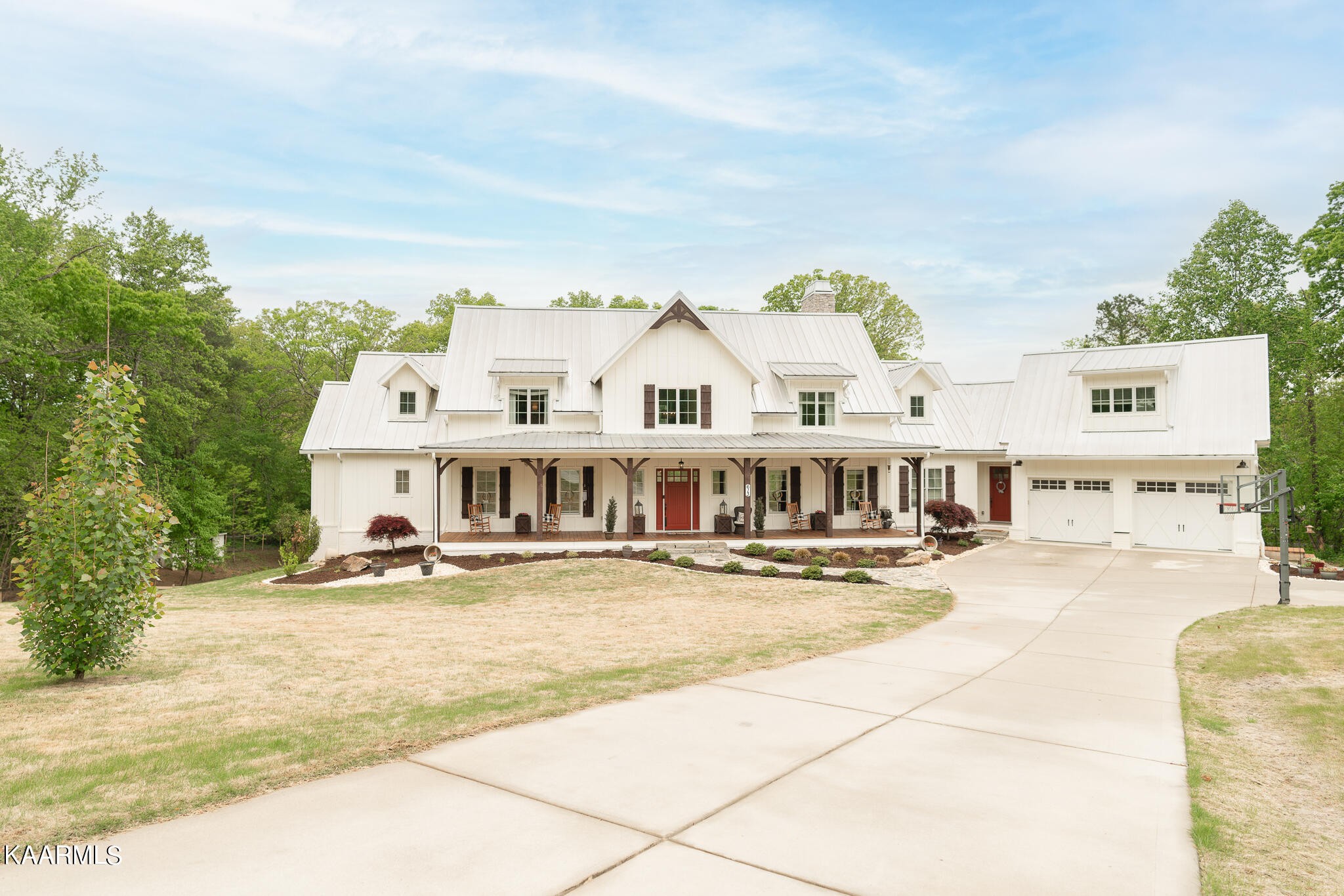 a view of a white house with swimming pool in front of it