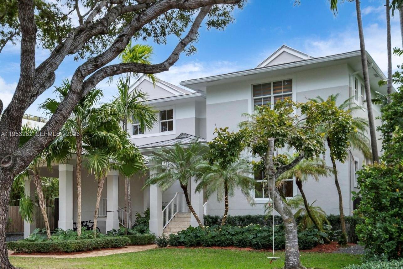 164 West Mashta Drive Key Biscayne, FL 33149 - Photo 1 of 34 a front view of a house with a garden and trees