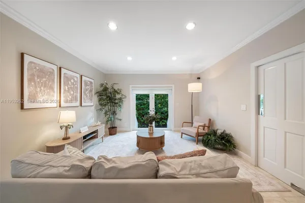 a living room with furniture and a potted plant