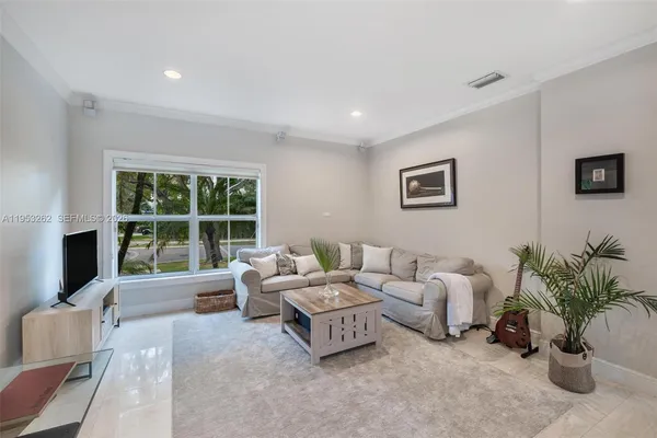 a living room with furniture large window and a flat screen tv