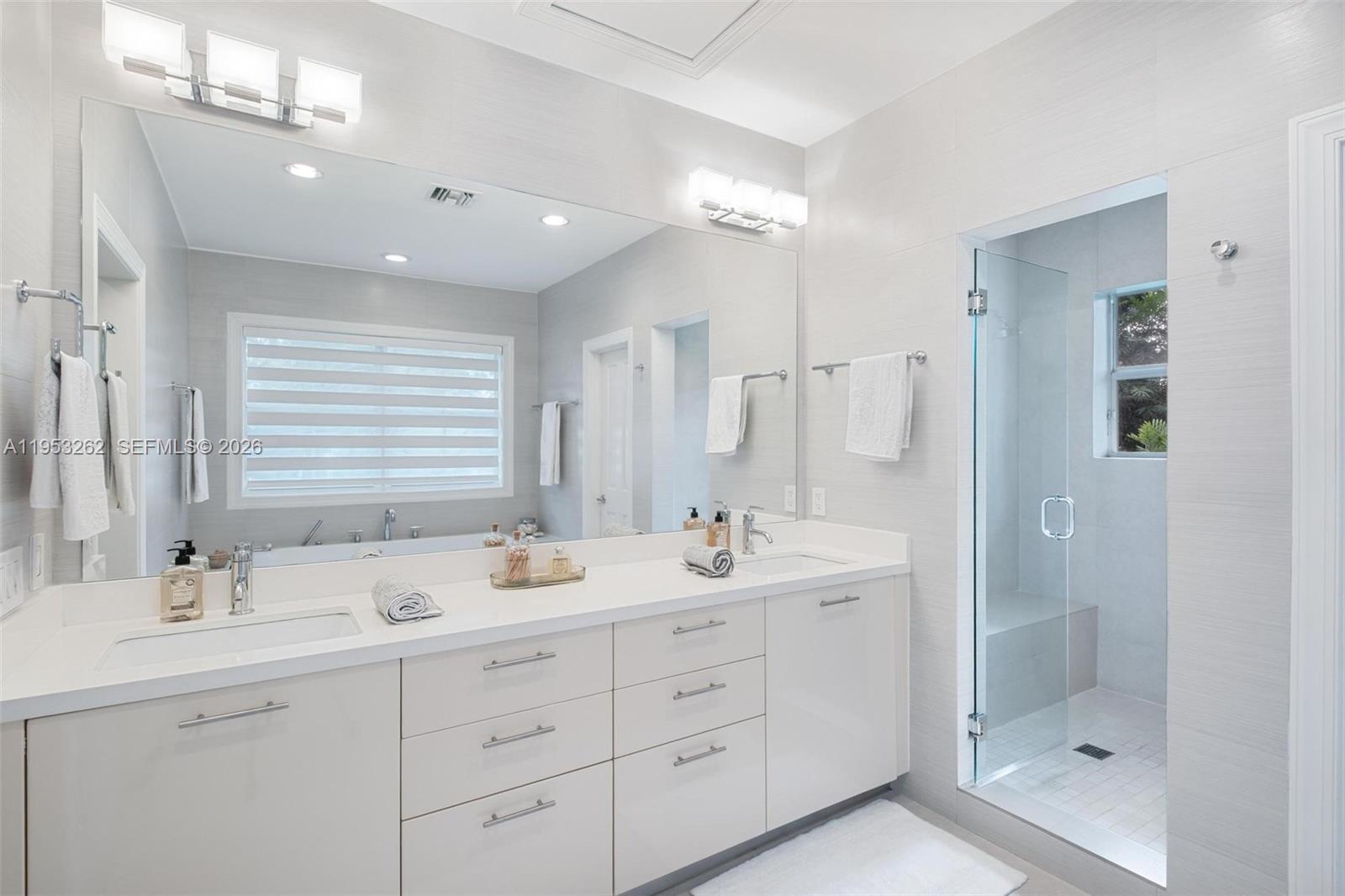 164 West Mashta Drive Key Biscayne, FL 33149 - Photo 20 of 34 a bathroom with double sink and a mirror