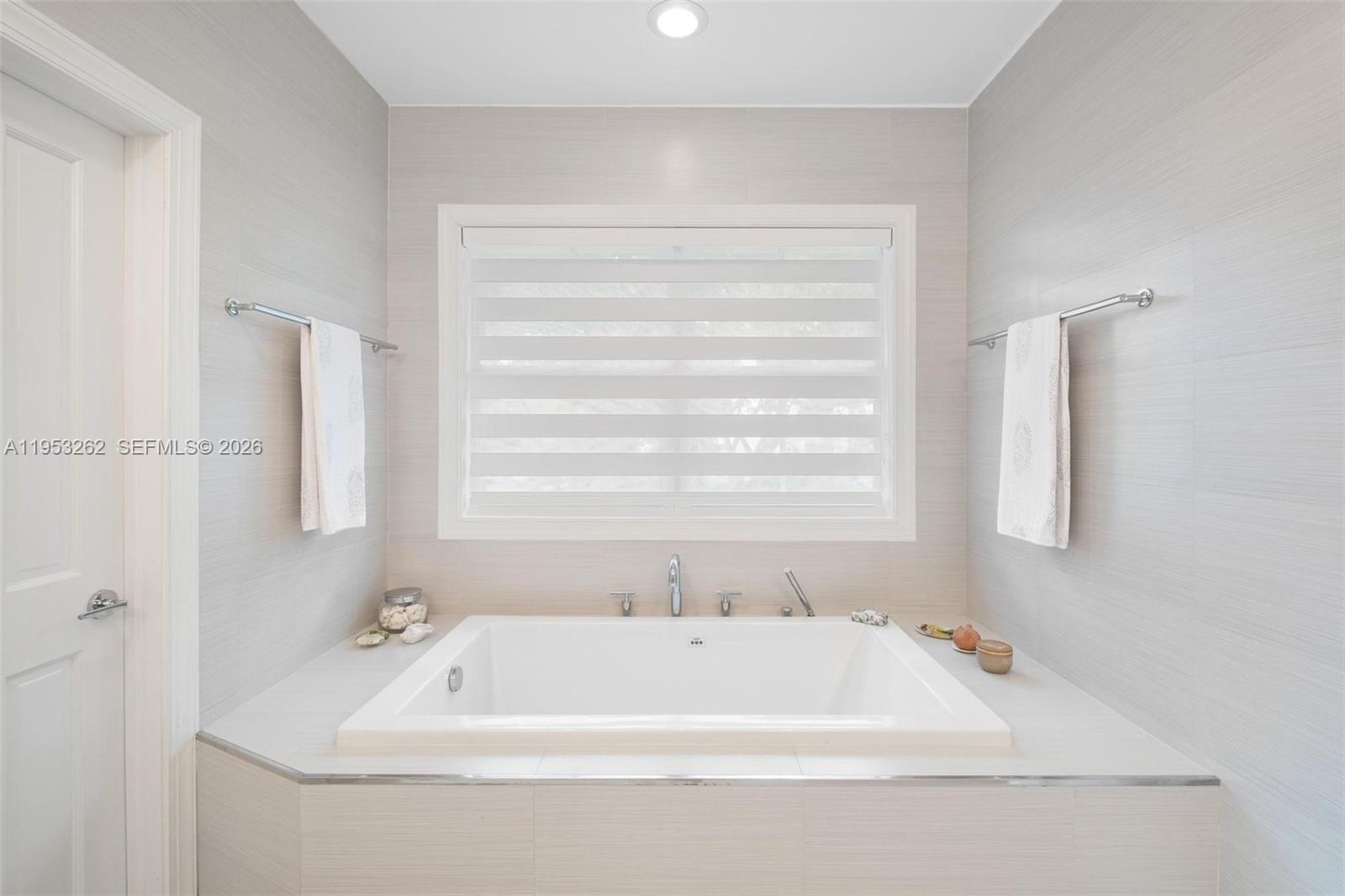 164 West Mashta Drive Key Biscayne, FL 33149 - Photo 21 of 34 a bathroom with a bathtub and a window