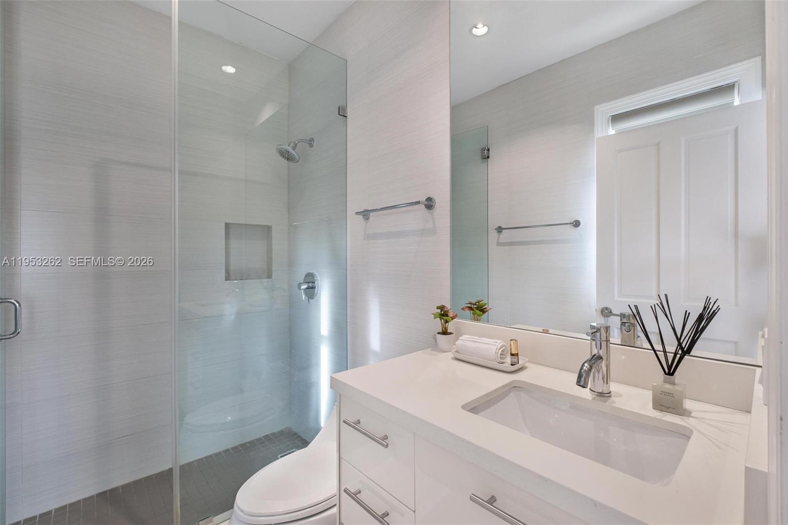 164 West Mashta Drive Key Biscayne, FL 33149 - Photo 23 of 34 a bathroom with a granite countertop sink toilet and shower