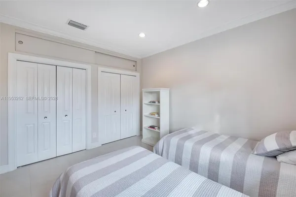 a bathroom with a bathtub shower sink vanity mirror and toilet