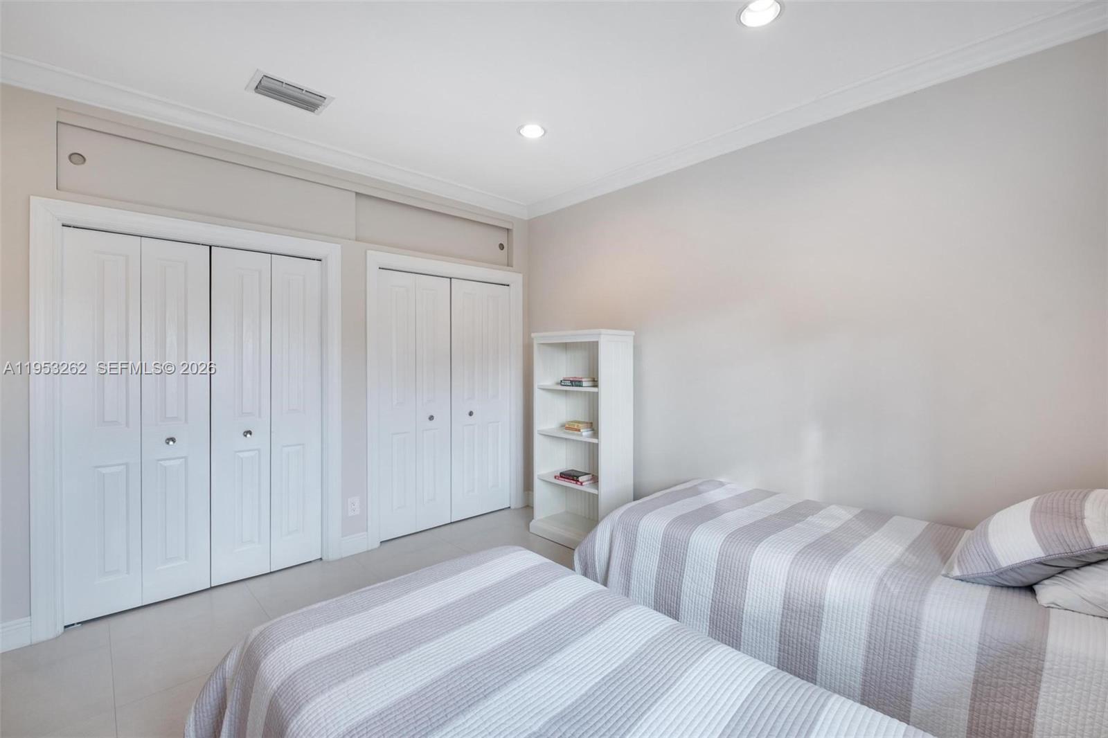 164 West Mashta Drive Key Biscayne, FL 33149 - Photo 24 of 34 a bedroom with a bed and a closet