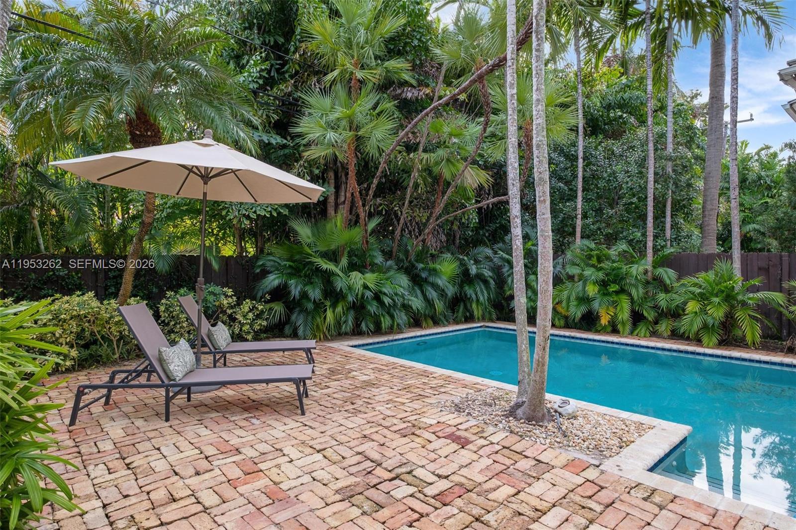 164 West Mashta Drive Key Biscayne, FL 33149 - Photo 26 of 34 a garden view with a seating space