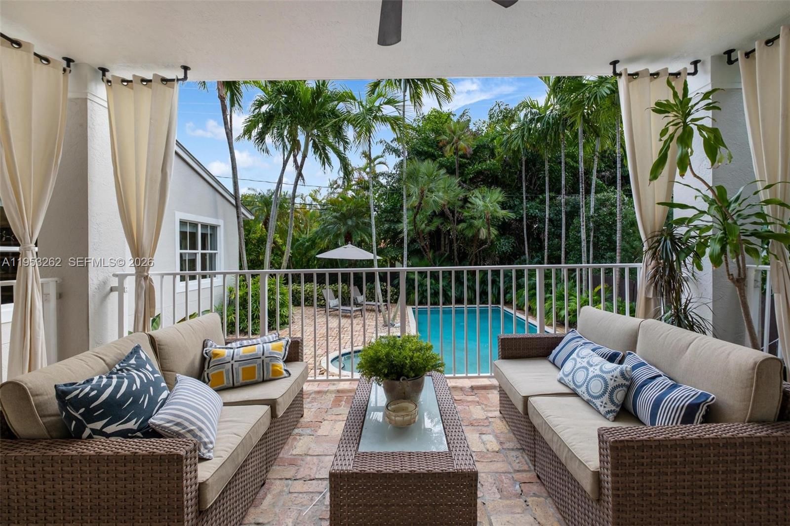 164 West Mashta Drive Key Biscayne, FL 33149 - Photo 4 of 34 a view of a patio with couches table and chairs
