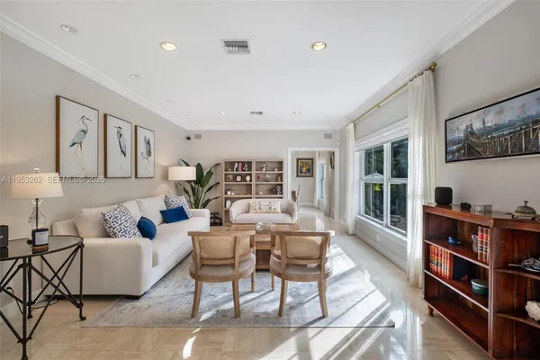a living room with furniture and a bookshelf
