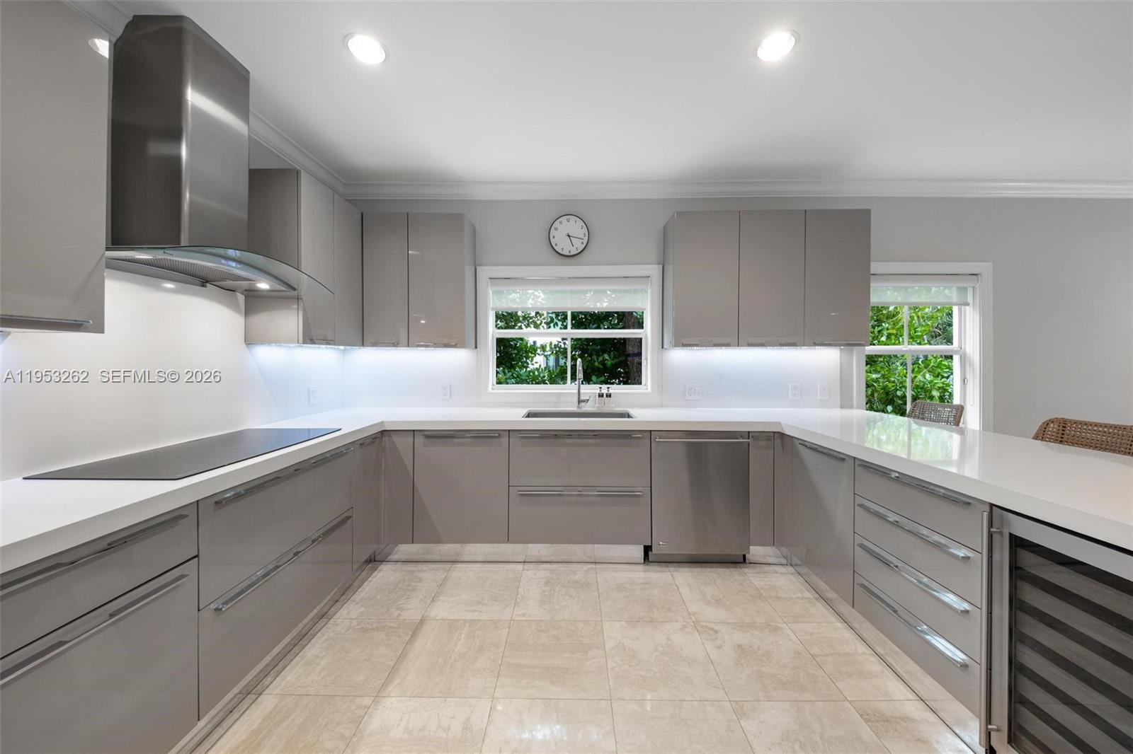 164 West Mashta Drive Key Biscayne, FL 33149 - Photo 10 of 34 a kitchen with white cabinets and window