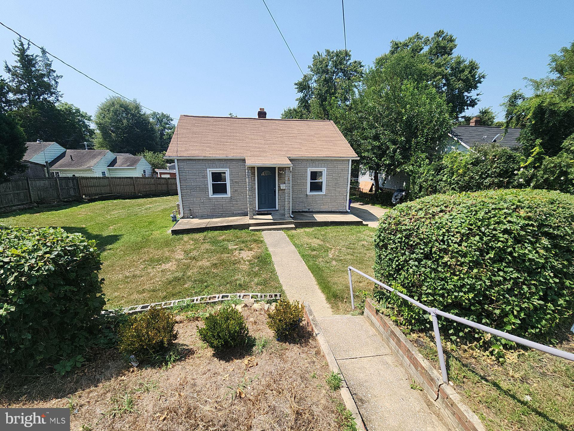 12024 Veirs Mill Road Silver Spring, MD 20906 - Photo 1 of 22 a view of backyard with potted plants and large tree