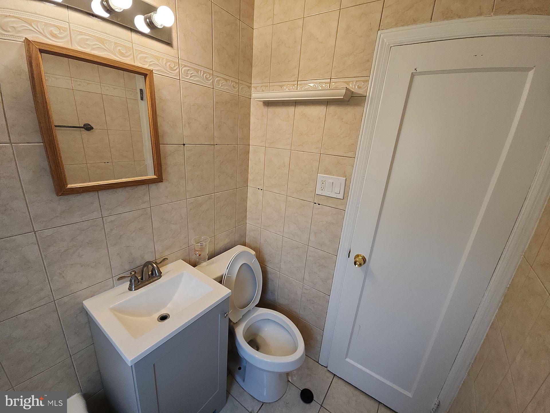 12024 Veirs Mill Road Silver Spring, MD 20906 - Photo 11 of 22 a white toilet sitting next to a bathroom sink