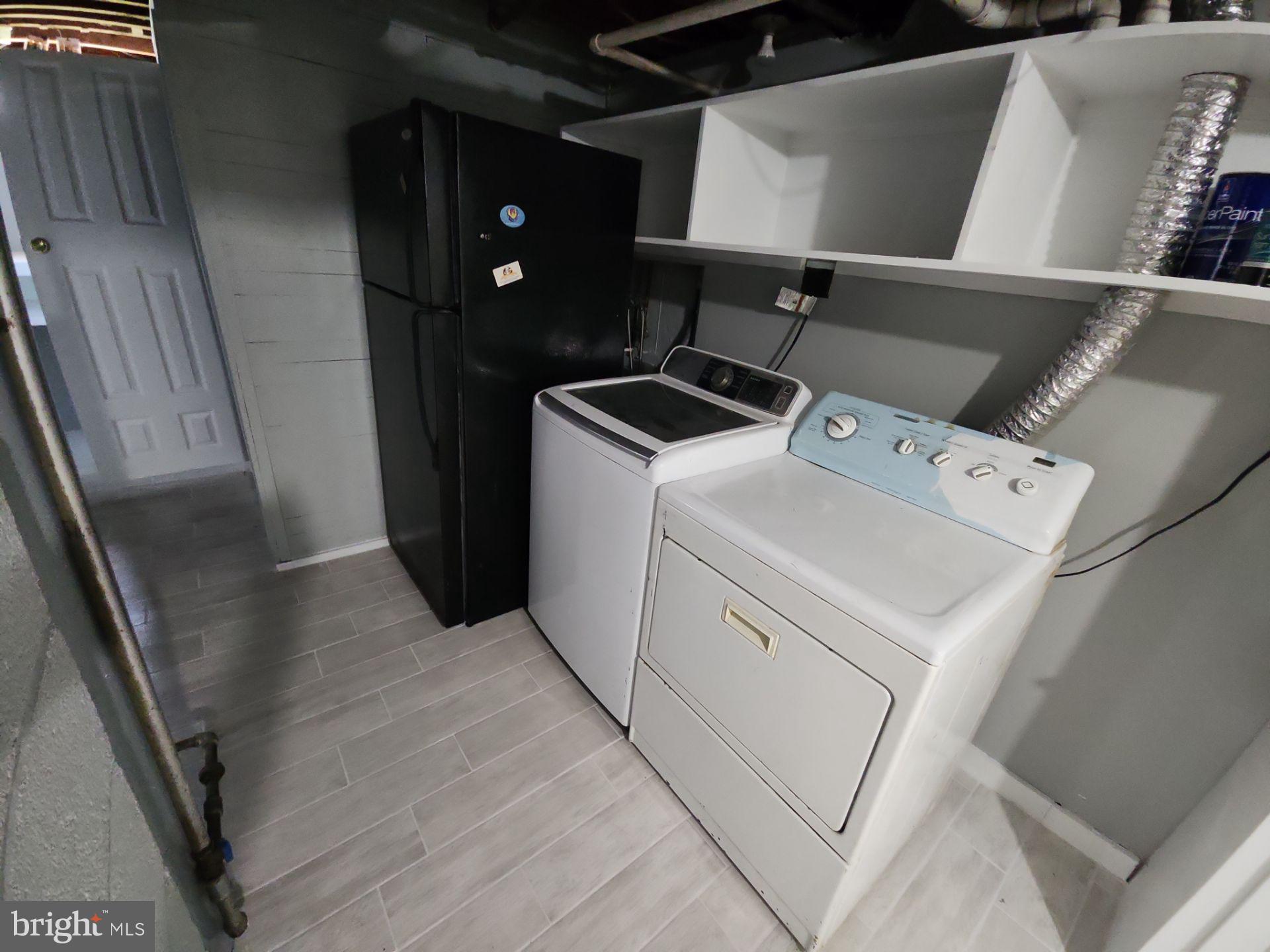 12024 Veirs Mill Road Silver Spring, MD 20906 - Photo 16 of 22 a view of storage and utility room with washer and dryer