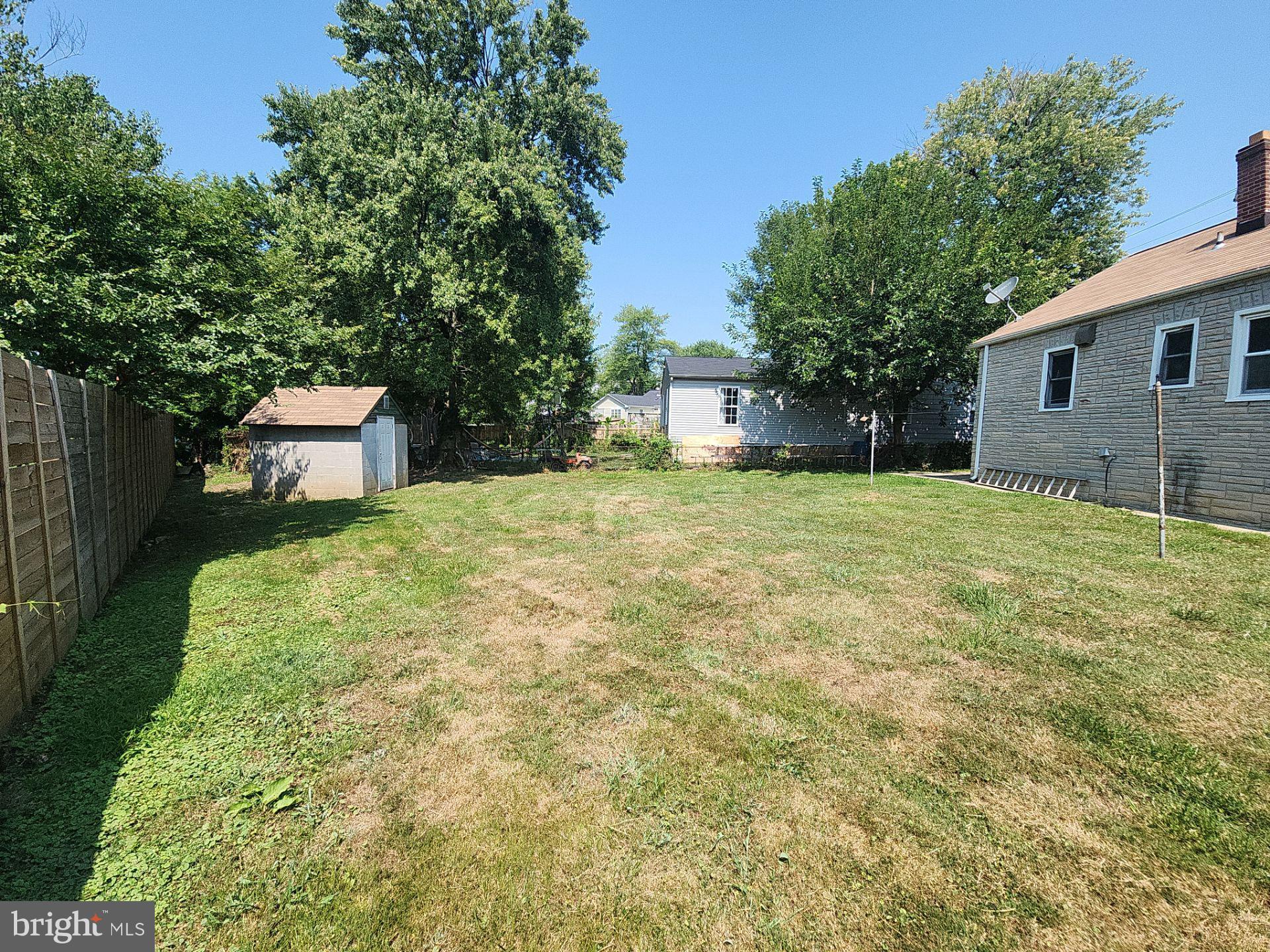 12024 Veirs Mill Road Silver Spring, MD 20906 - Photo 22 of 22 a backyard of a house with large trees