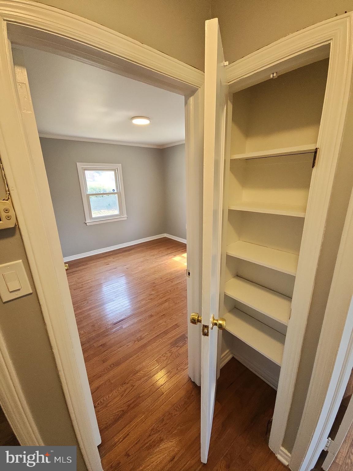 12024 Veirs Mill Road Silver Spring, MD 20906 - Photo 5 of 22 a view of an empty room with wooden floor and windows