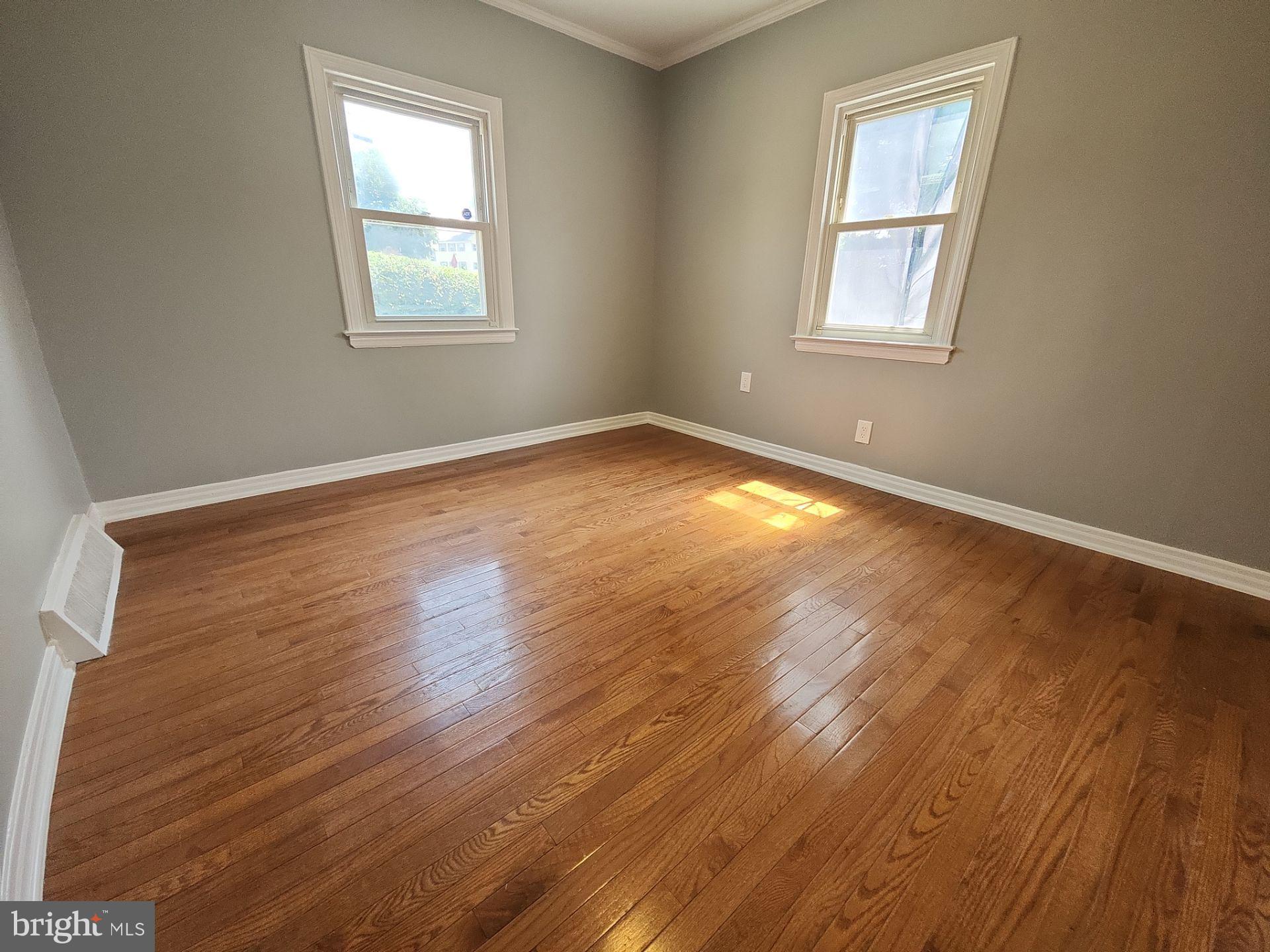 12024 Veirs Mill Road Silver Spring, MD 20906 - Photo 6 of 22 an empty room with wooden floor and windows