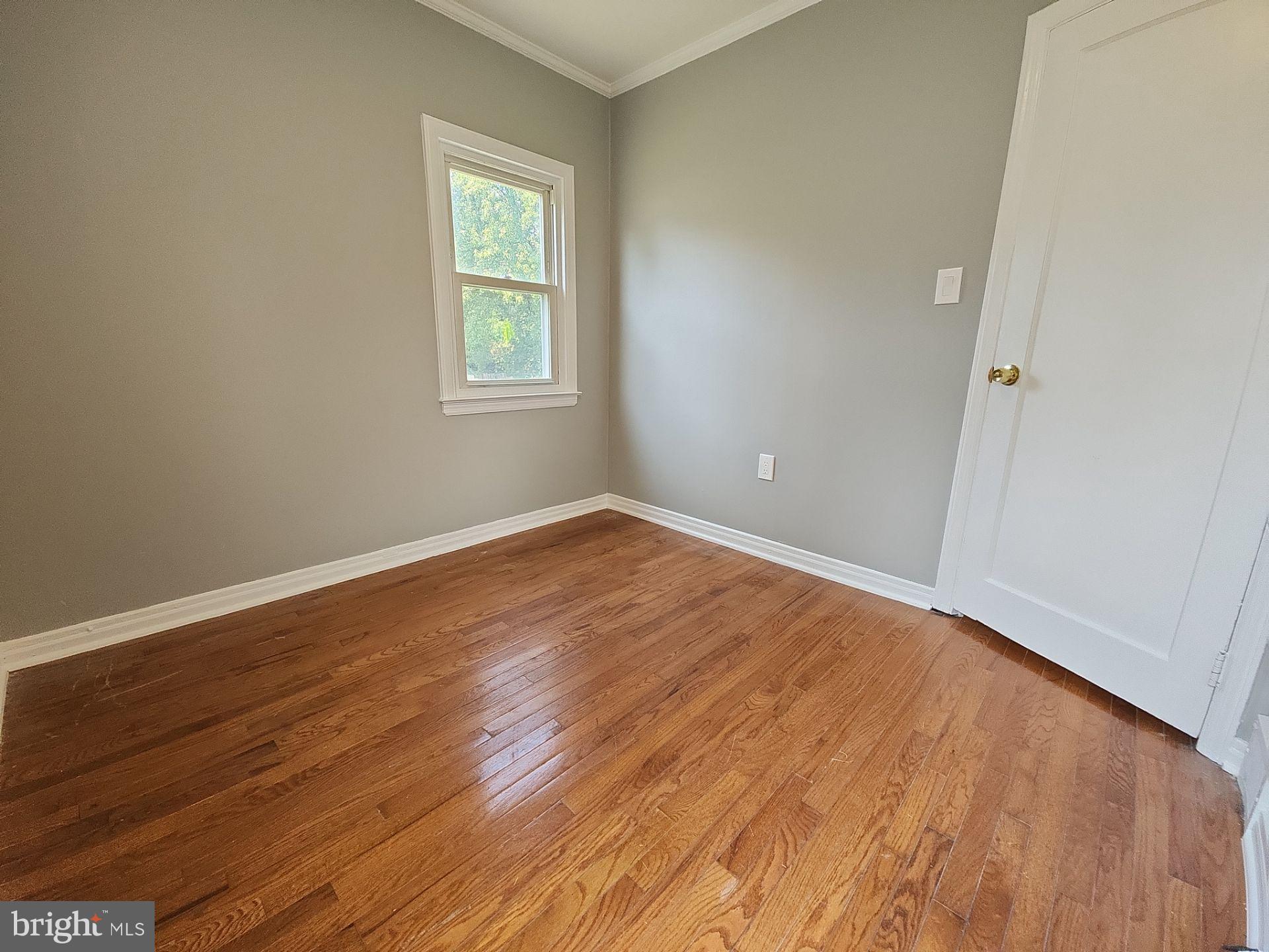12024 Veirs Mill Road Silver Spring, MD 20906 - Photo 9 of 22 an empty room with wooden floor and windows