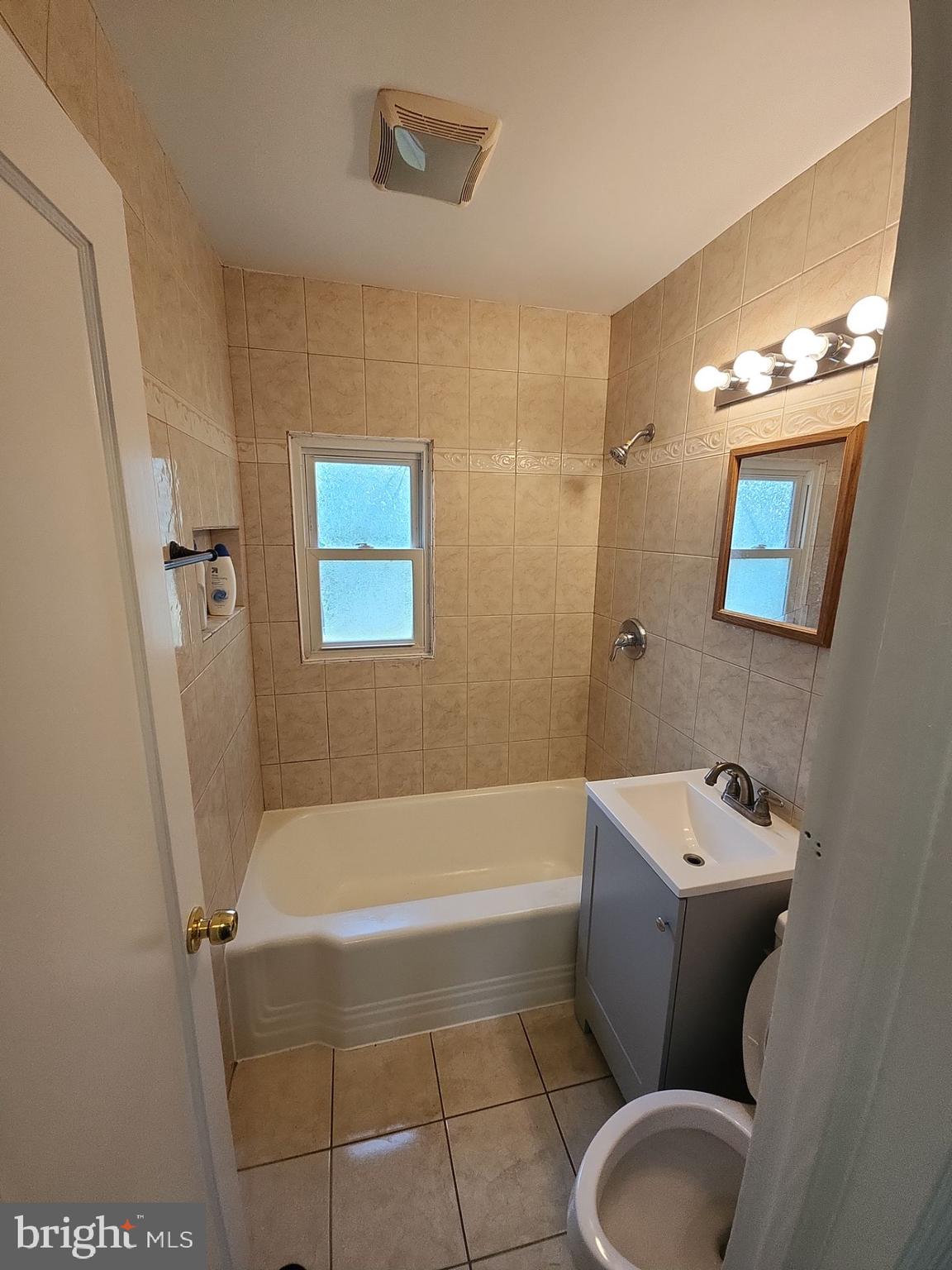 12024 Veirs Mill Road Silver Spring, MD 20906 - Photo 10 of 22 a bathroom with a toilet and bathtub