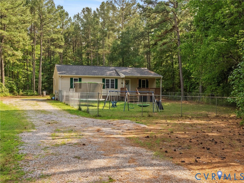 14175 Lebanon Road Disputanta, VA 23842 - Photo 10 of 60 Gravel driveway leading to a residence with a ligh