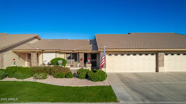 an aerial view of a house with a yard