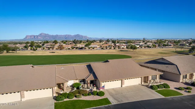 an aerial view of a house with a garden and houses