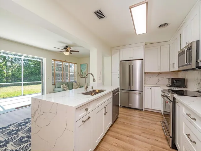 a kitchen with a stove a sink and a refrigerator