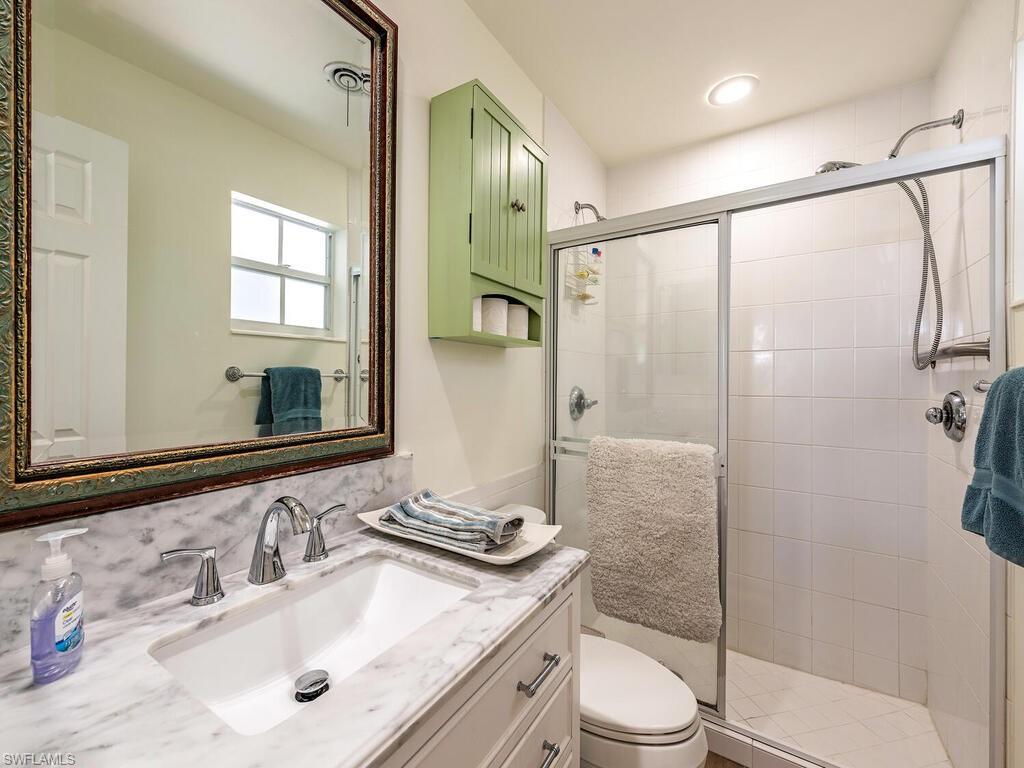 1471 Mandarin Road Naples, FL 34102 - Photo 14 of 28 a bathroom with a sink toilet and shower
