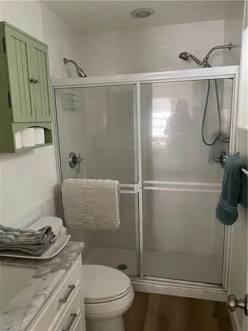 a bathroom with a shower a toilet and a sink