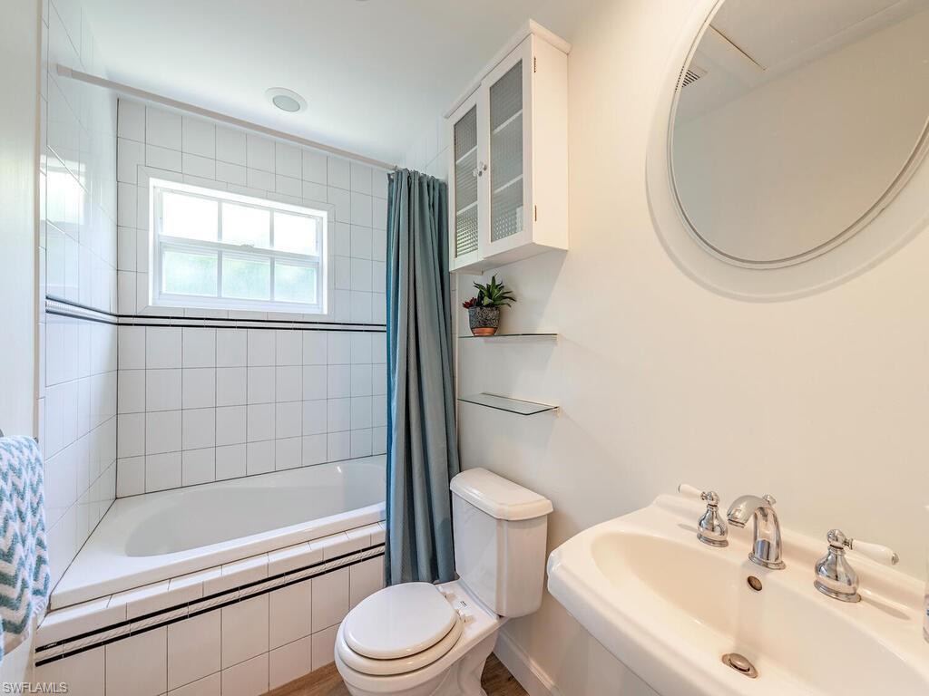 1471 Mandarin Road Naples, FL 34102 - Photo 17 of 28 a bathroom with a sink toilet and shower