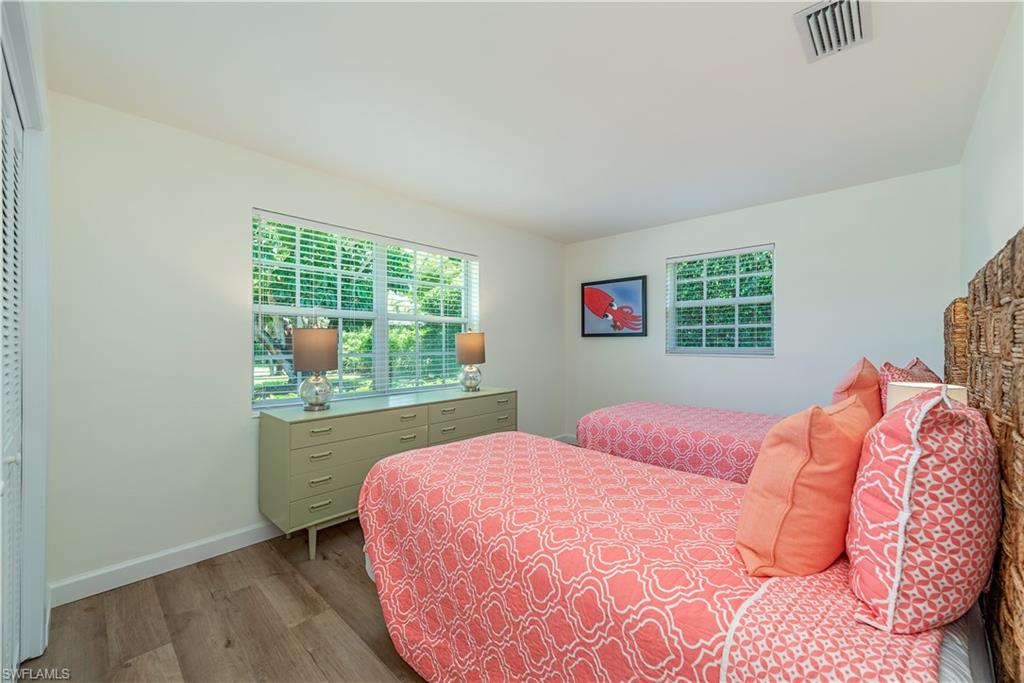 1471 Mandarin Road Naples, FL 34102 - Photo 20 of 28 a bedroom with a bed and a window
