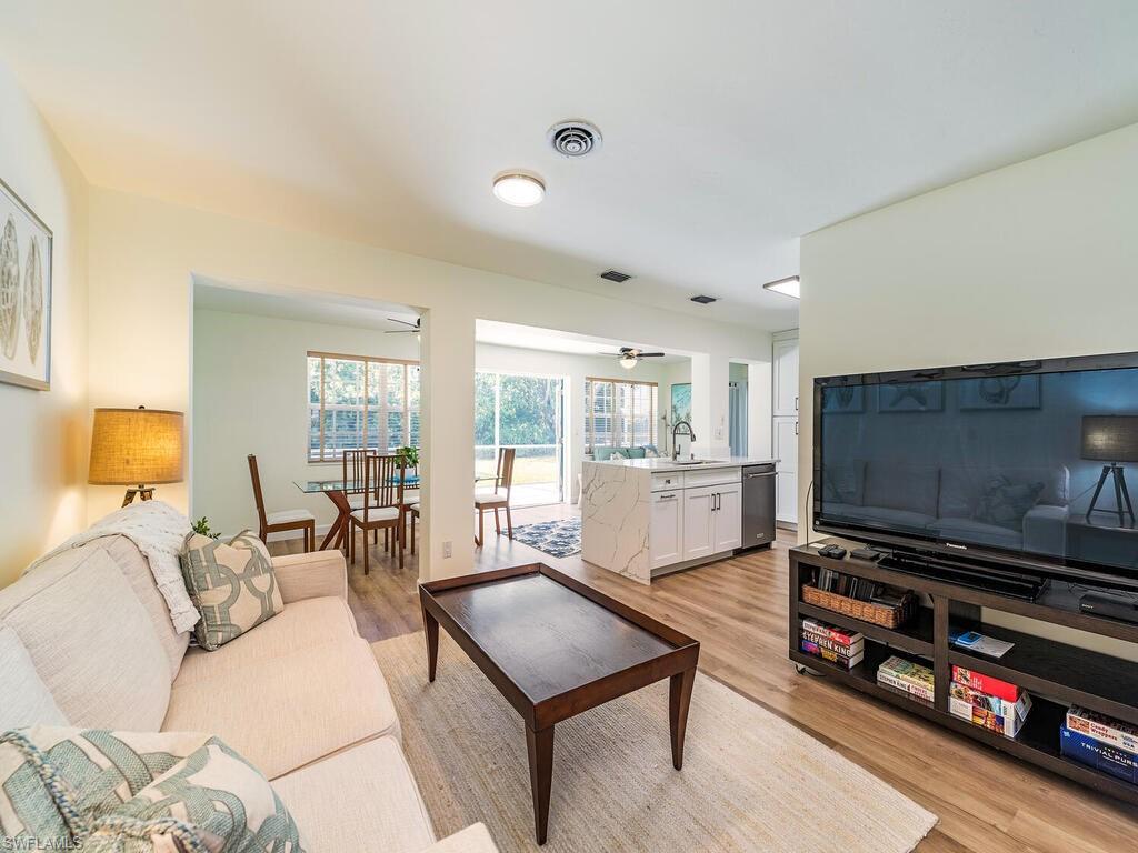 1471 Mandarin Road Naples, FL 34102 - Photo 2 of 28 a living room with furniture and a flat screen tv
