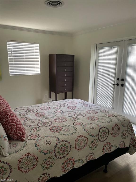1471 Mandarin Road Naples, FL 34102 - Photo 21 of 28 a bedroom with a bed and a window