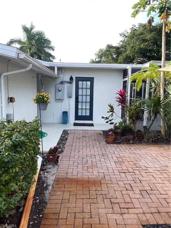 1471 Mandarin Road Naples, FL 34102 - Photo 23 of 28 a front view of a house with garden
