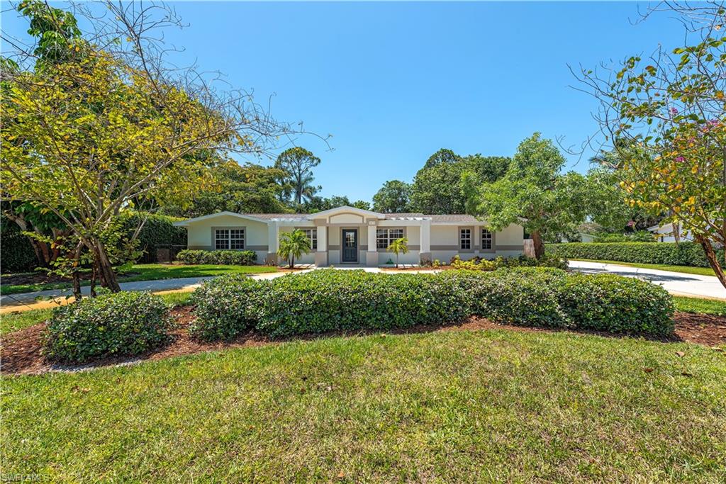 1471 Mandarin Road Naples, FL 34102 - Photo 26 of 28 a front view of a house with a yard