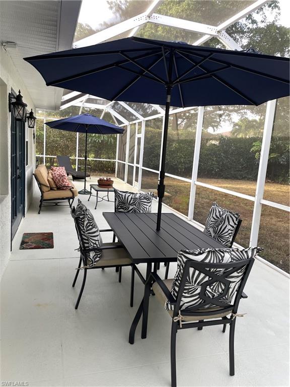 1471 Mandarin Road Naples, FL 34102 - Photo 27 of 28 a view of a patio with table and chairs under an umbrella