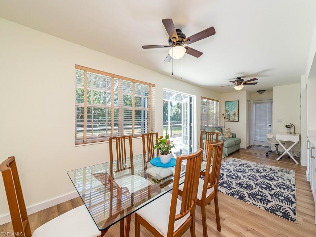 1471 Mandarin Road Naples, FL 34102 - Photo 3 of 28 a dining room with furniture window and wooden floor