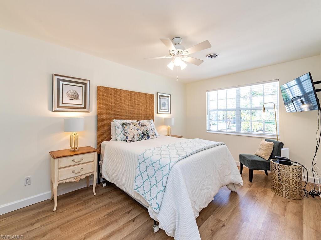 1471 Mandarin Road Naples, FL 34102 - Photo 4 of 28 a bedroom with a bed and a window