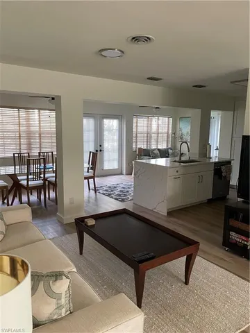 a living room with furniture a rug and a large window