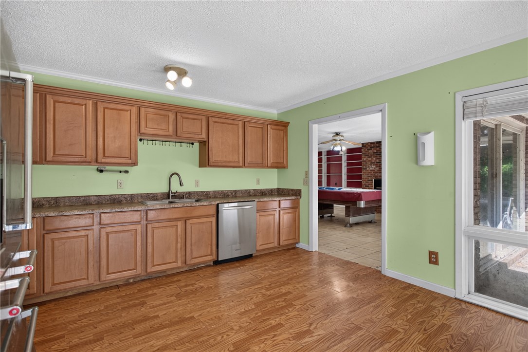 123 Robin Road Westminster, SC 29693 - Photo 19 of 50 A functional kitchen space offers rich wooden cabinetry and a built-in dishwasher, flowing into a lively entertainment room.
