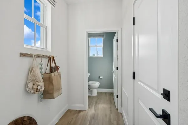 a bathroom with a toilet and a walk in closet