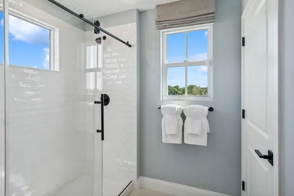 a bathroom with a window and a shower