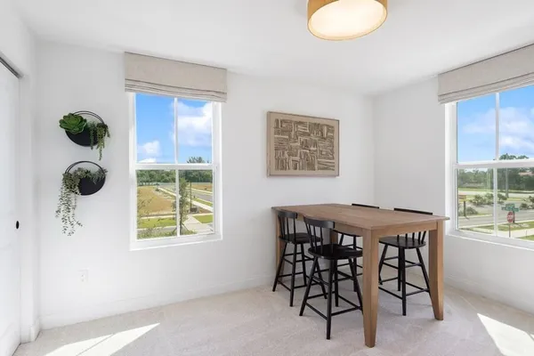 a dining room with furniture and front door