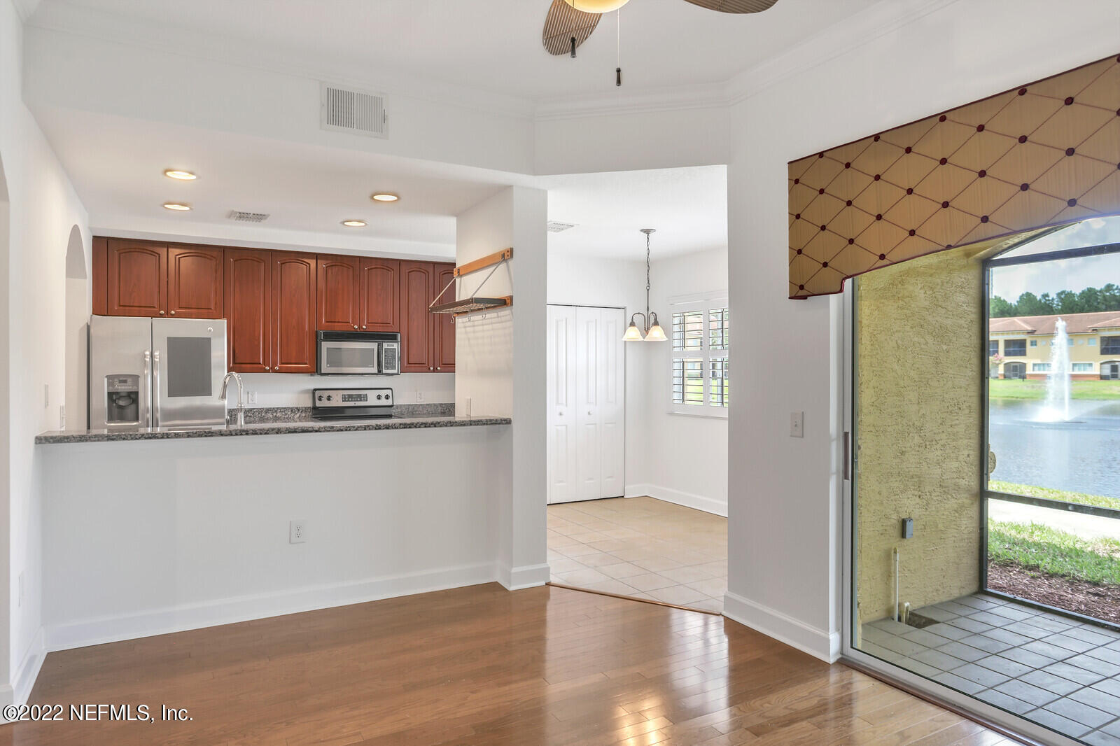 9745 Touchton Road, Unit 2806 Jacksonville, FL 32246 - Photo 17 of 32 a kitchen with stainless steel appliances a refrigerator and a stove top oven