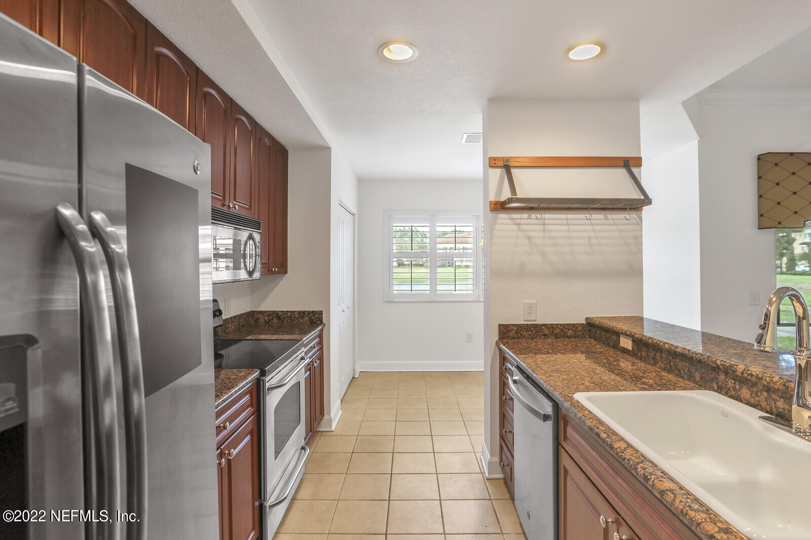 9745 Touchton Road, Unit 2806 Jacksonville, FL 32246 - Photo 20 of 32 a kitchen that has a sink a stove top oven a refrigerator and a sink