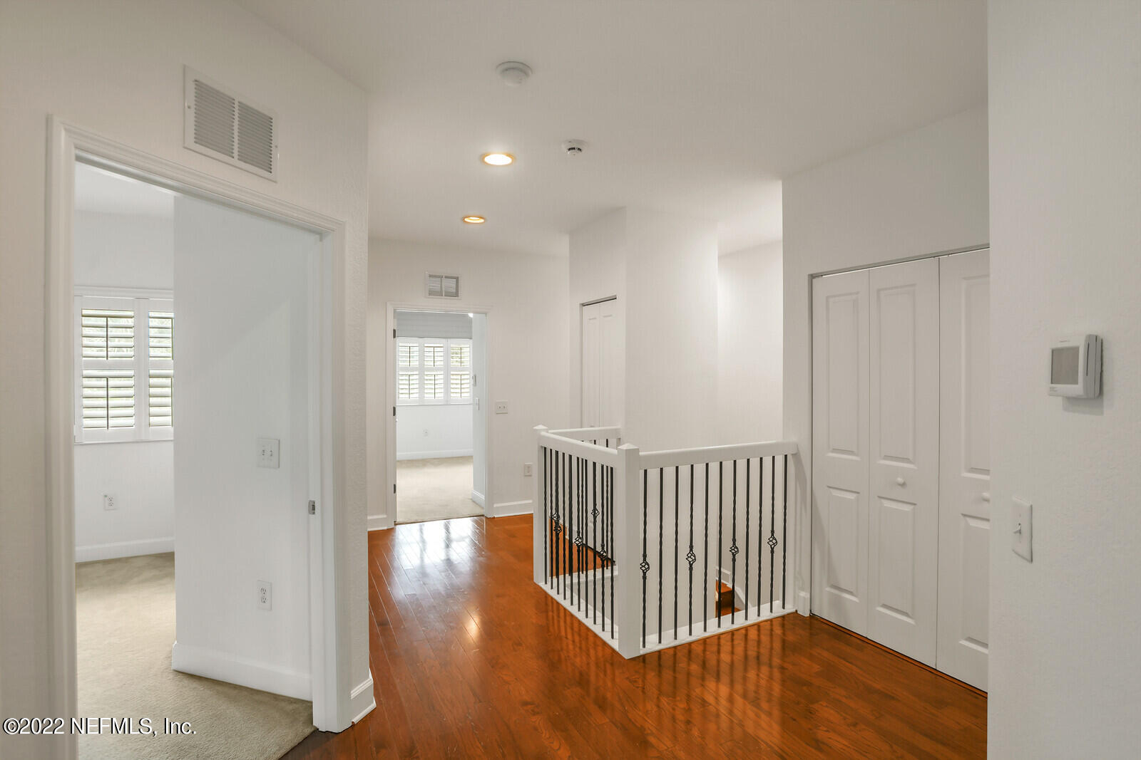 9745 Touchton Road, Unit 2806 Jacksonville, FL 32246 - Photo 23 of 32 a view of a hallway with wooden floor and windows
