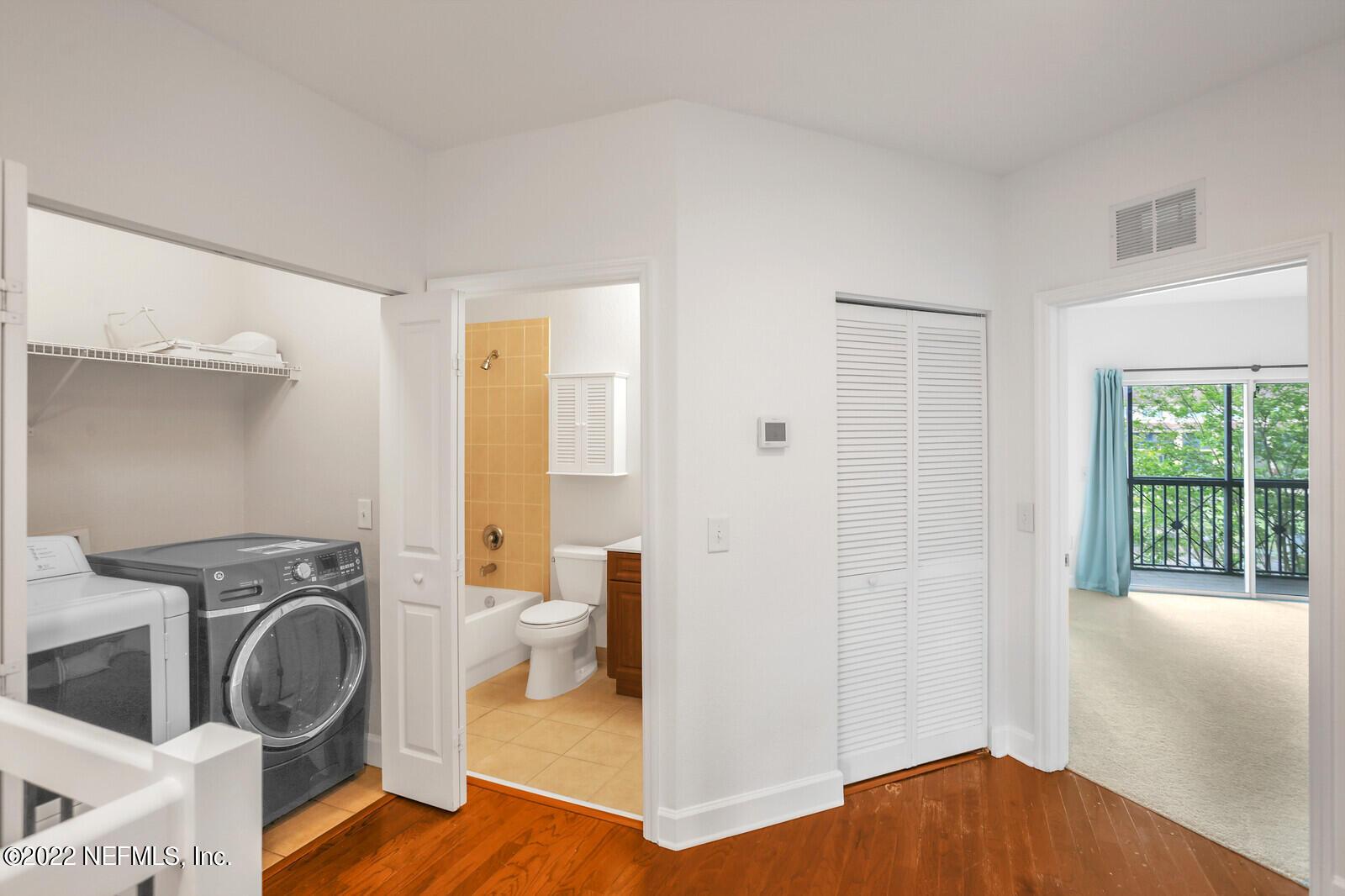 9745 Touchton Road, Unit 2806 Jacksonville, FL 32246 - Photo 24 of 32 a view of a bedroom with washer and dryer