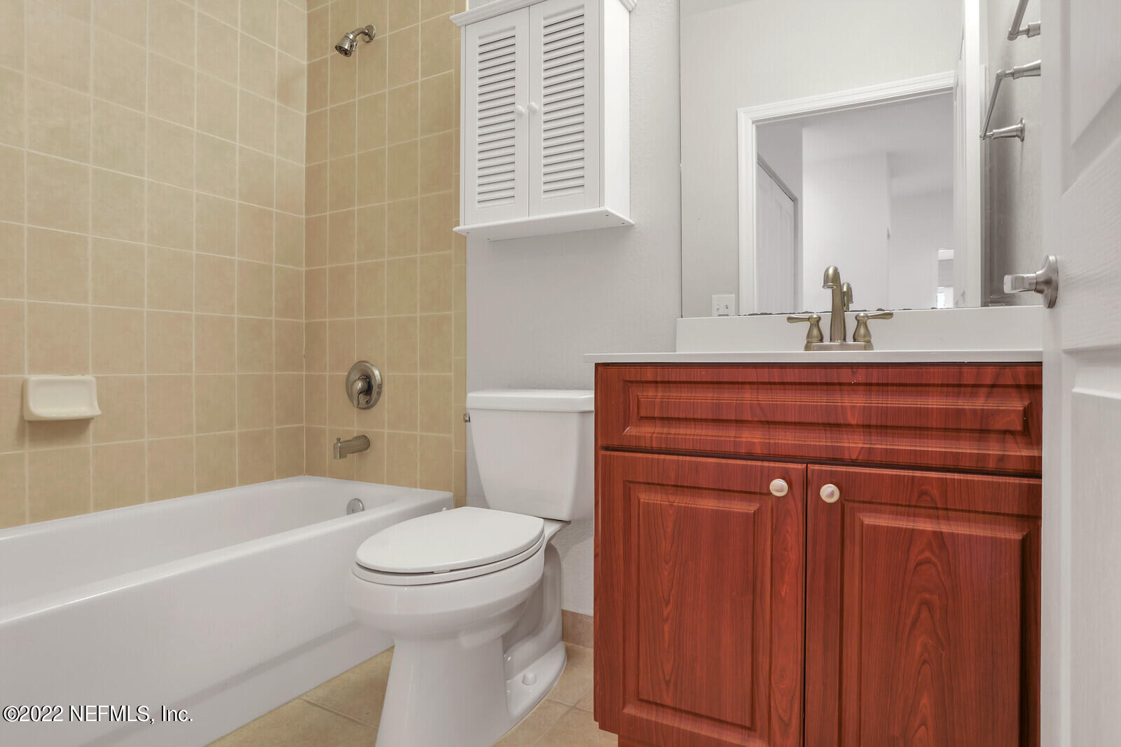 9745 Touchton Road, Unit 2806 Jacksonville, FL 32246 - Photo 31 of 32 a bathroom with a sink a toilet and bathtub